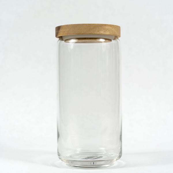 Large size of glass jar with acacia wood lid sitting in front of a white background.