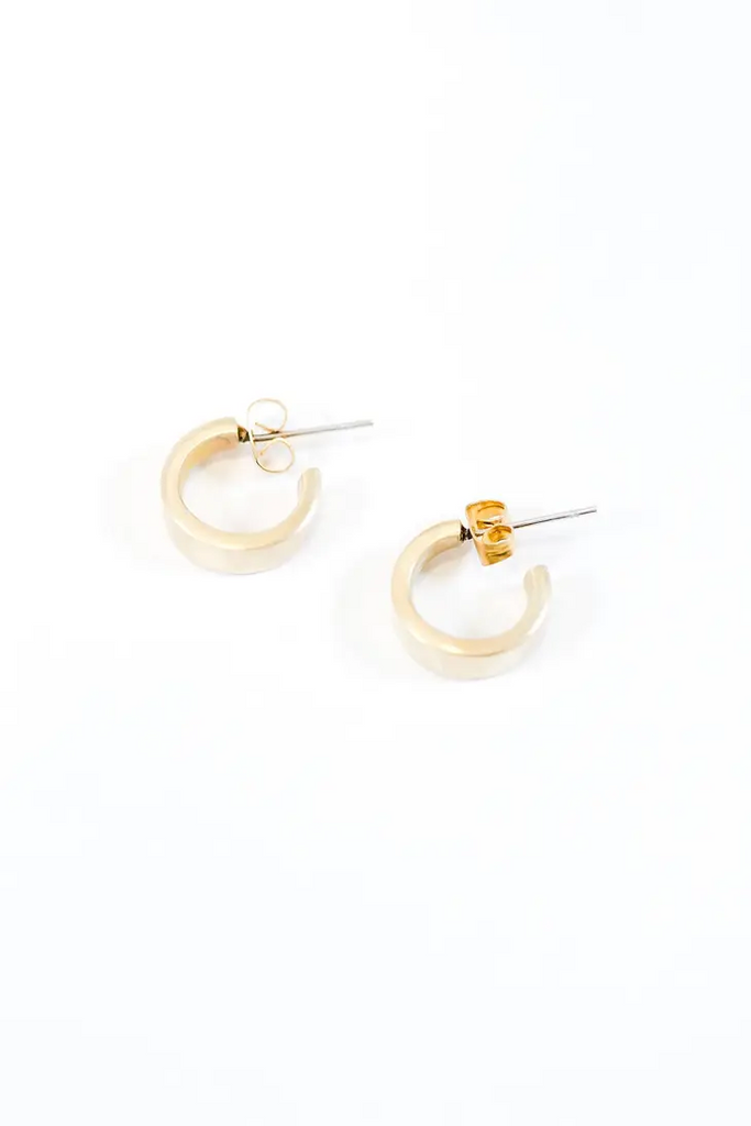 Small gold hoop earrings on a white background.