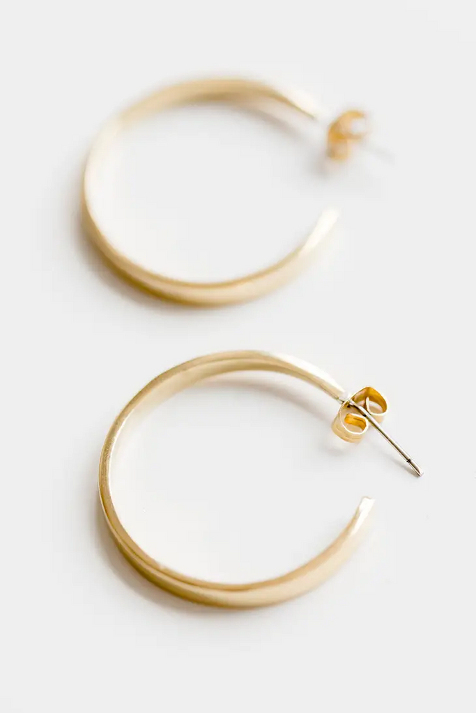 Medium gold hoop earrings on a white background.