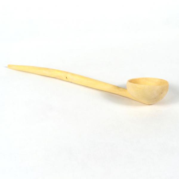 Round scoop with long handle carved from lemon wood. White background.