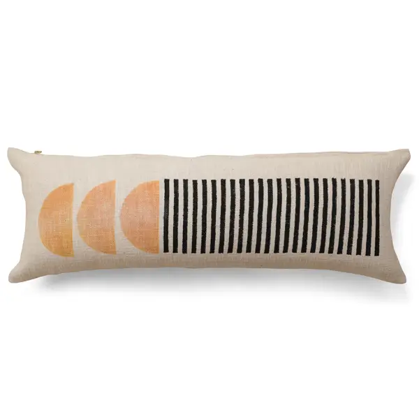 Long, slim cotton lumbar pillow with tangerine toned half circles on the left side and black vertical stripes on the left side.