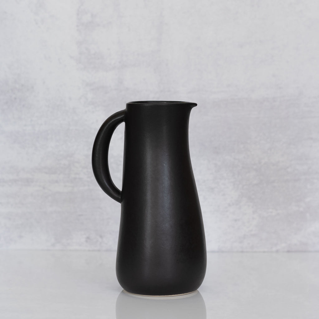Curvy matte black handled stoneware jug from Tunisia.