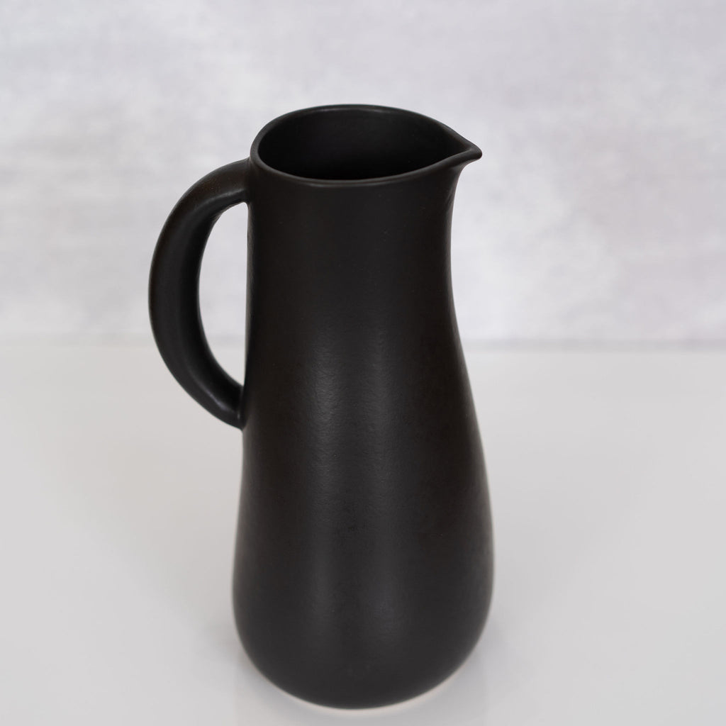 Curvy matte black handled stoneware jug from Tunisia.