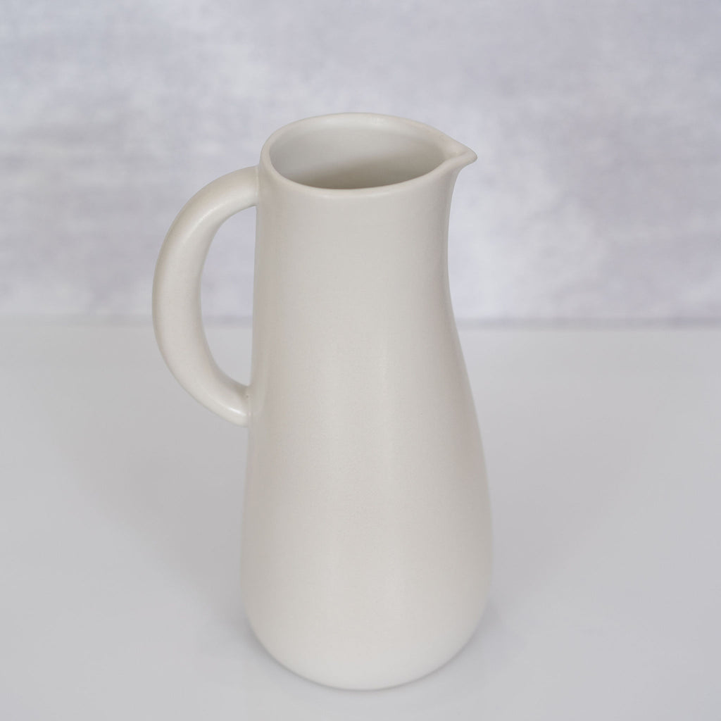Curvy matte white handled stoneware jug from Tunisia.