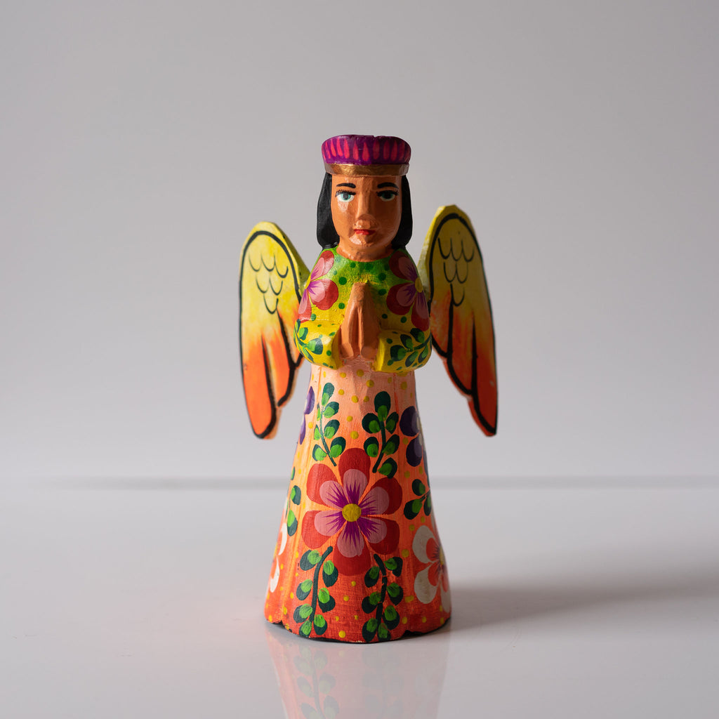 A brightly painted floral Christmas tree topper angel with an overall warm color scheme. Hand carved with painted realistic face.