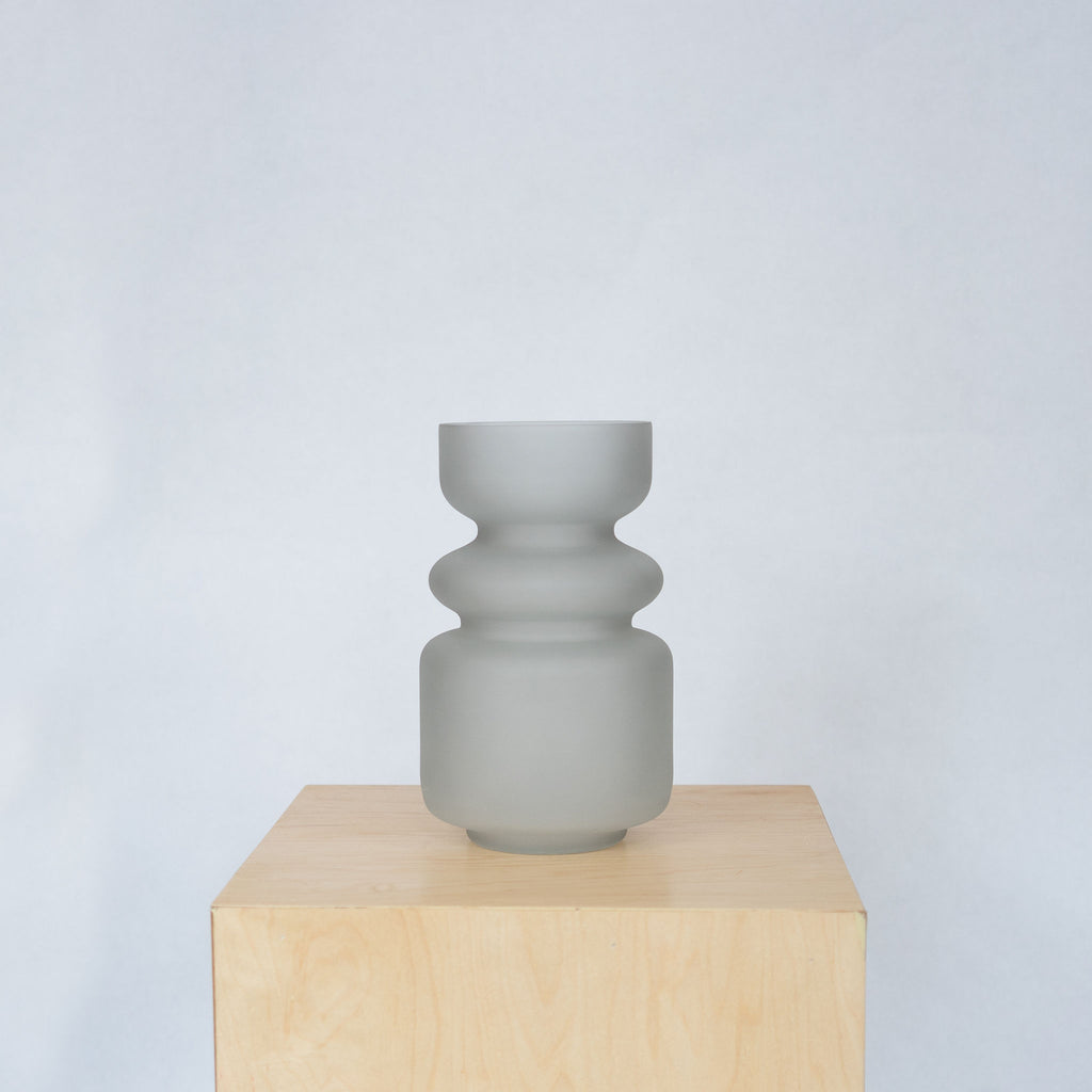 Handblown matte gray colored glass vase with 3 curvy sections.