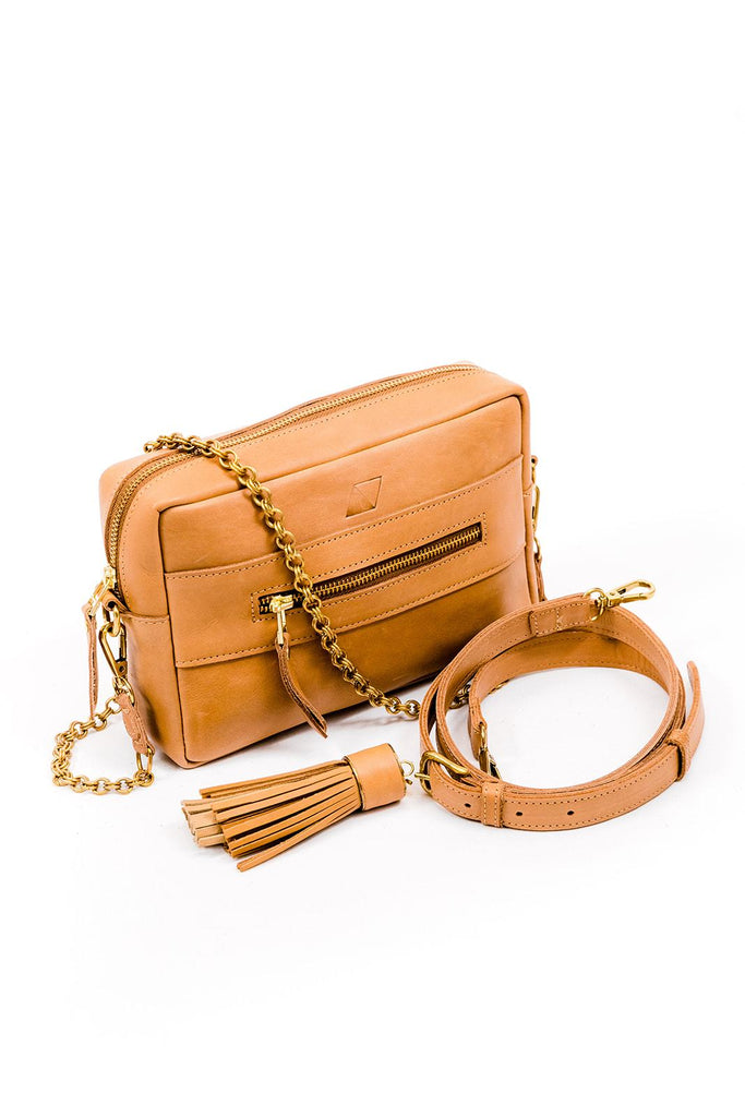 Tan leather rectangular purse with interchangeable chain and  leather straps. Leather strap includes a big tan leather tassel.