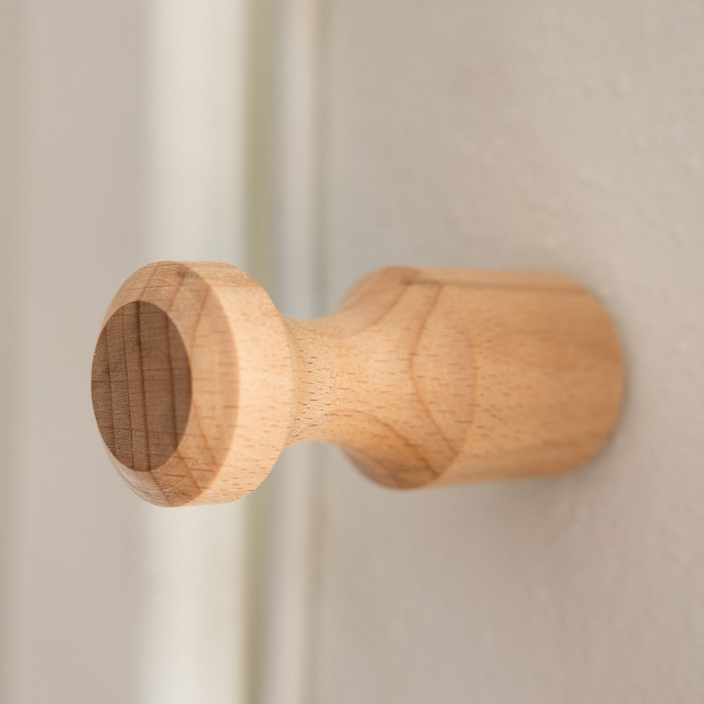 3" hand turned beechwood knob or peg. Installed on a white wall.