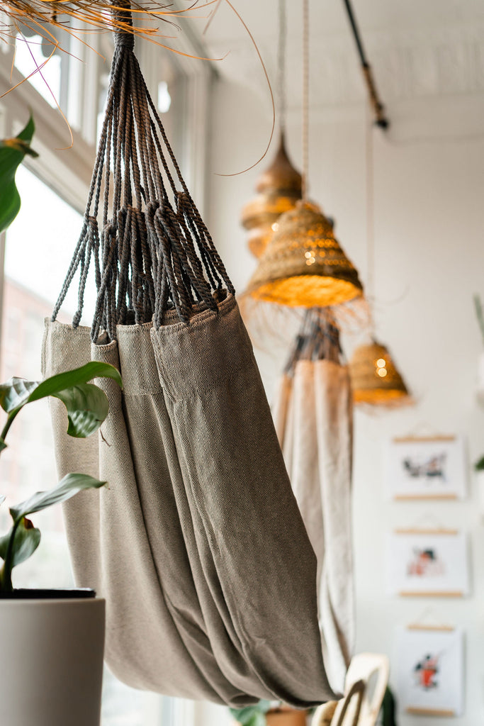 Handwoven and Recycled Gray Hammock with Macrame Hanging Loop hangs in Store Front Display Window