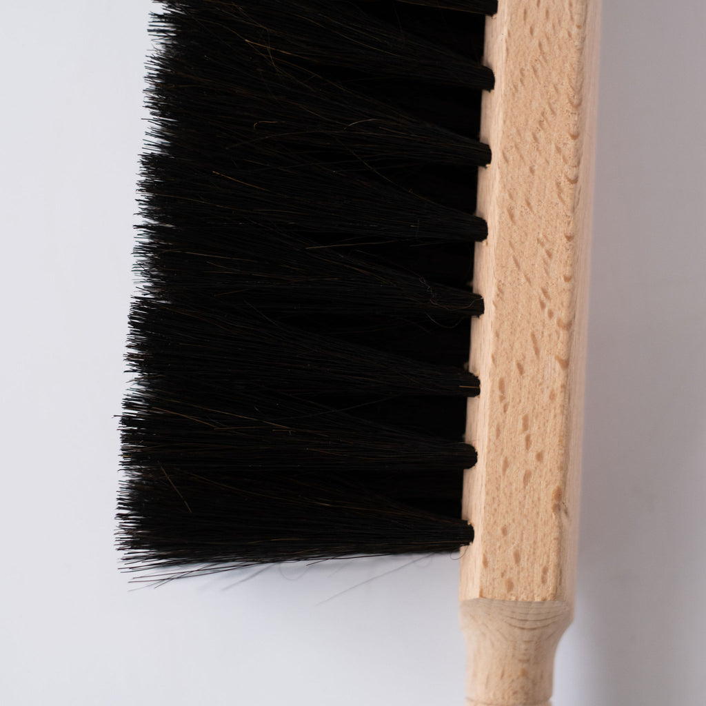 Beechwood handle and black horsehair brush on white background. Close up of bristles.
