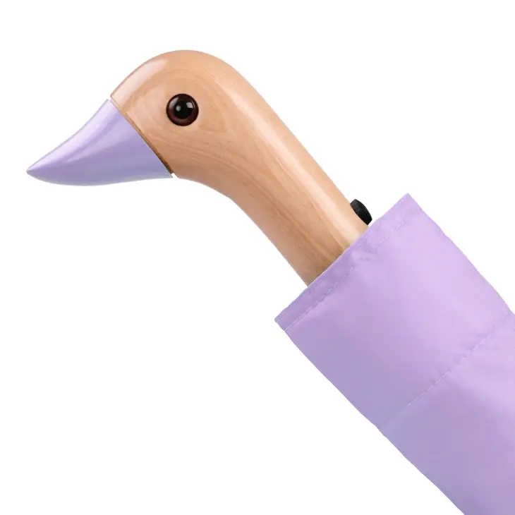 Close up of duck head handle on a lilac duckhead compact umbrella on a white background.