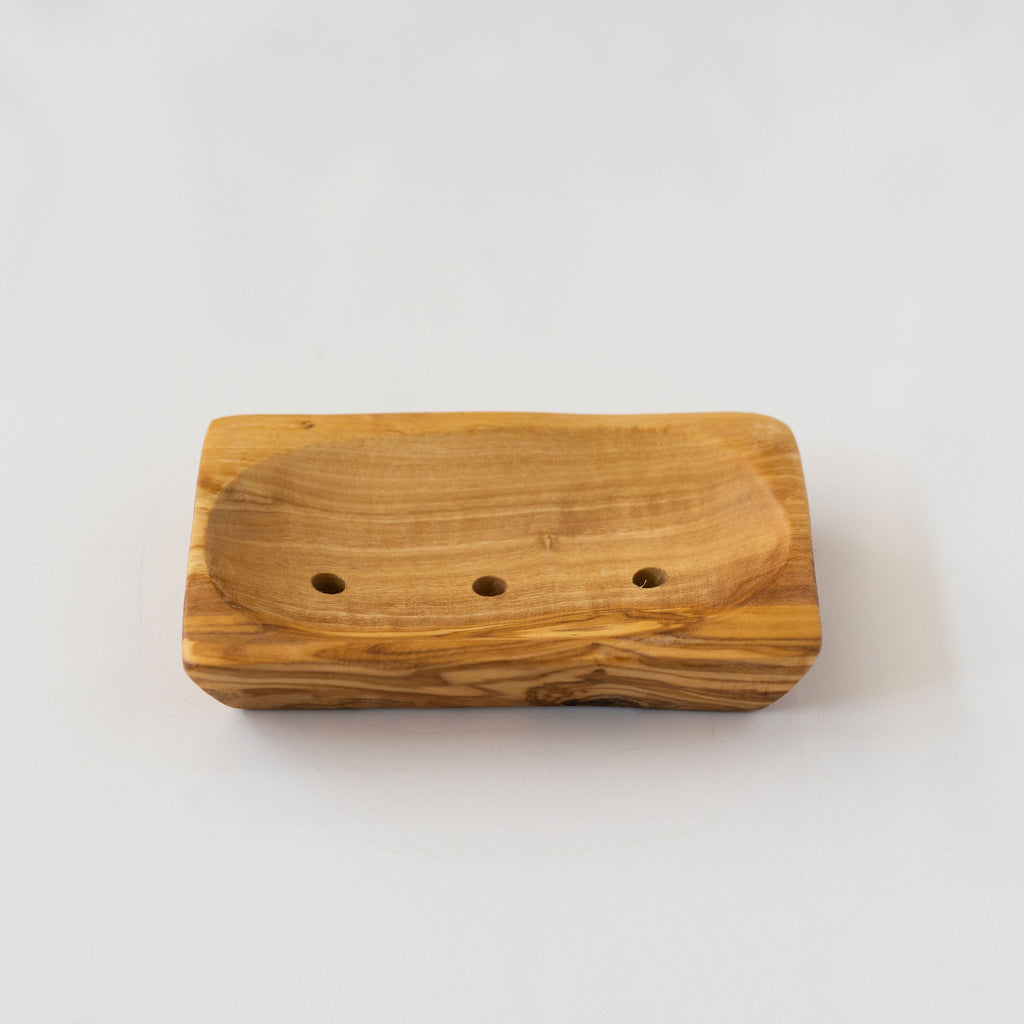 Rectangle olive wood soap dish with drainage holes. Light gray background.