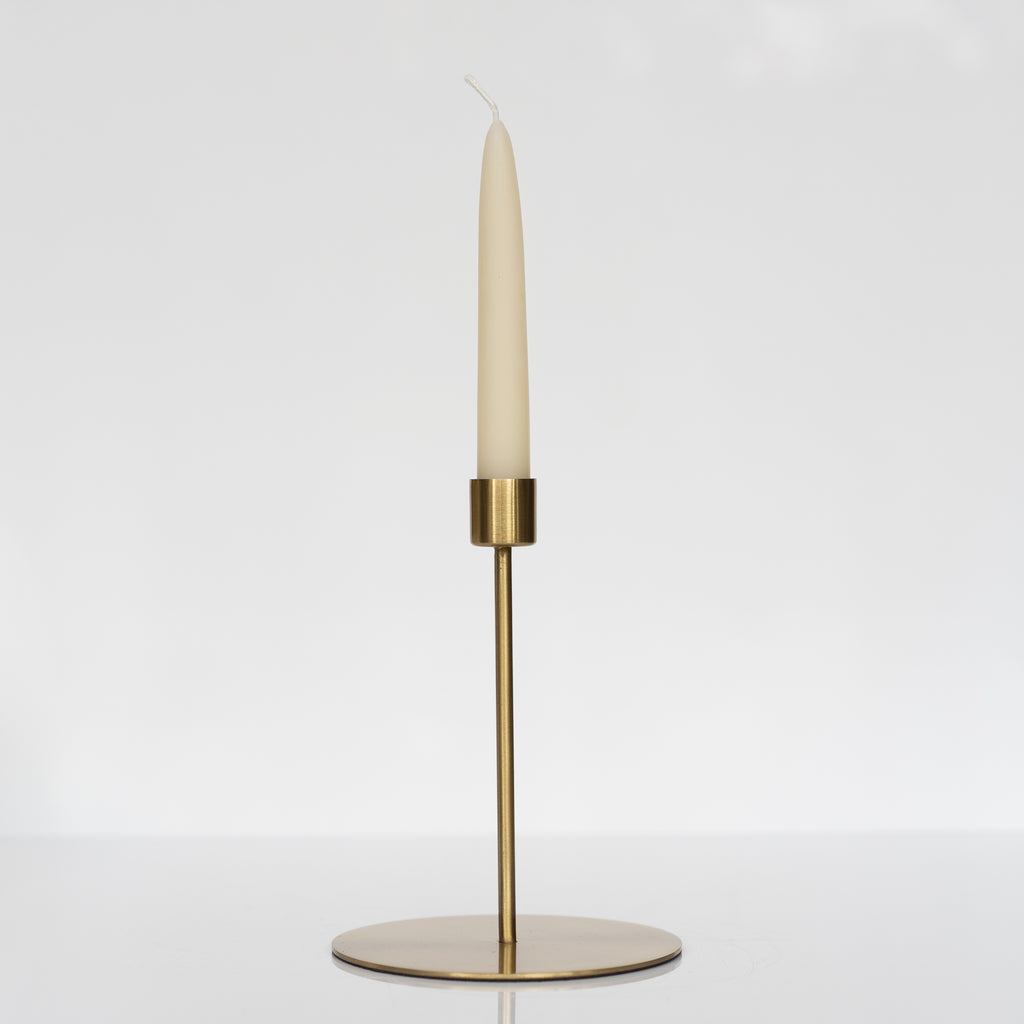 Tall size of gold finish taper candle holder. It has a large round flat base with a thin stem and perfectly sized cup for the taper candle.