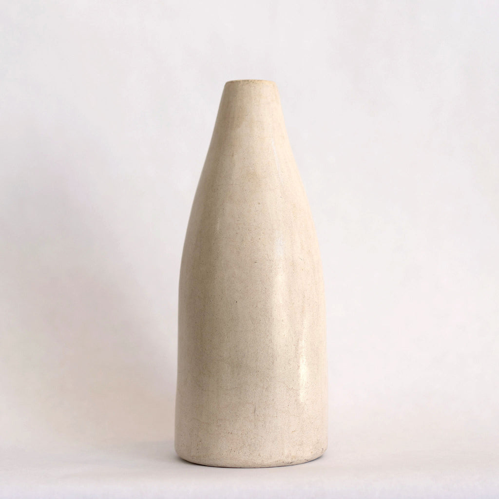 One short slim creamy ivory Tadelakt vase. White background.