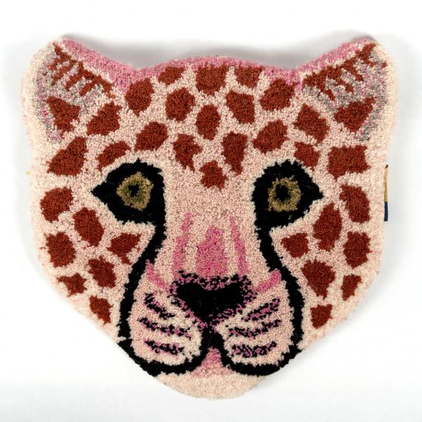 Hand-tufted wool rug shaped like a pink leopard cub head laying flat on a white background. A beautifully crafted and detailed pink leopard face.