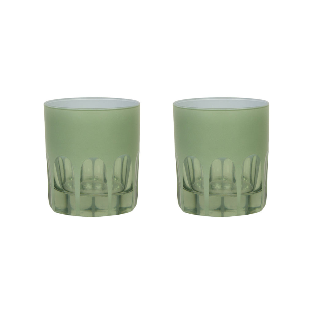 Pair of pale green toned handblown glasses with a mix of opaque and transparent arches along the bottom. White background.
