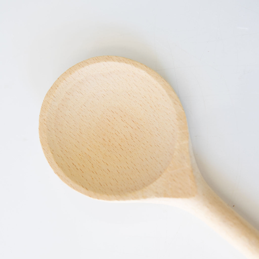 Beechwood round cooking spoon. Close up on spoon end.