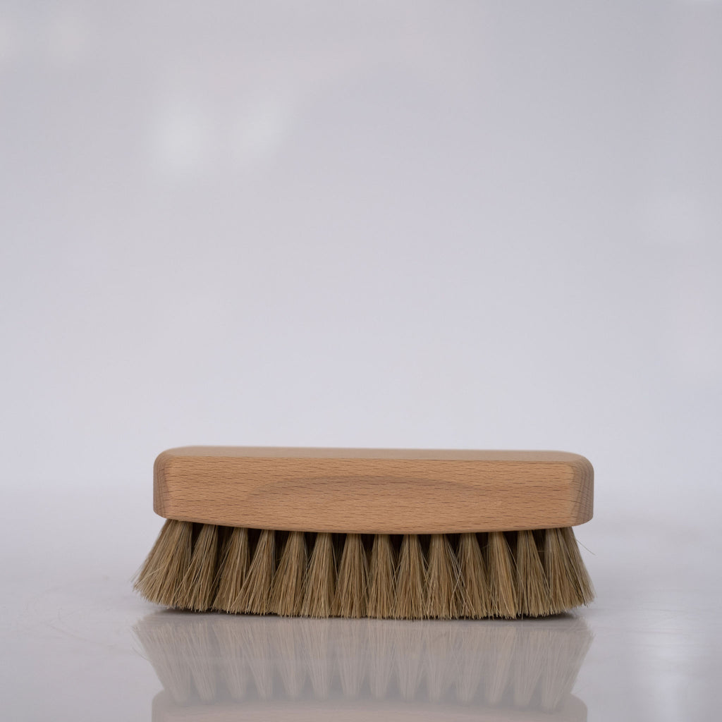 Beechwood and horse hair shoeshine brush on white background.