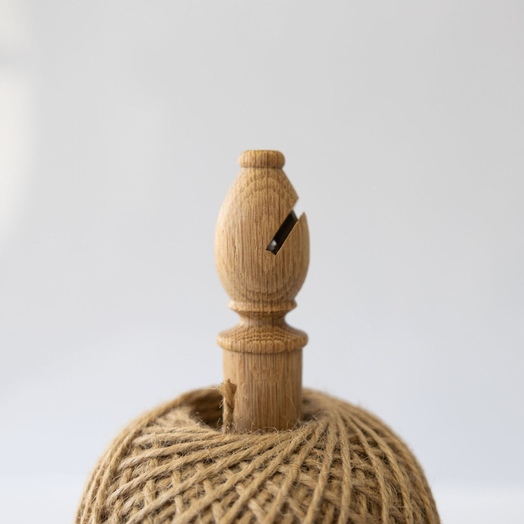 Bishops twine stand with cutter, complete with 250 grams of natural twine. Close up on cutter at top of stand.