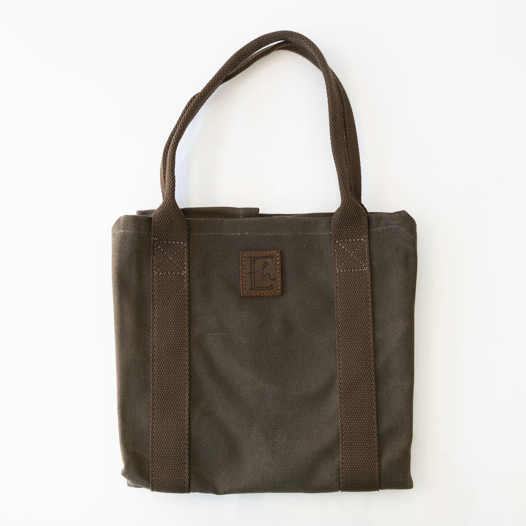 Brown waxed canvas log and flower handle with rolled canvas handles