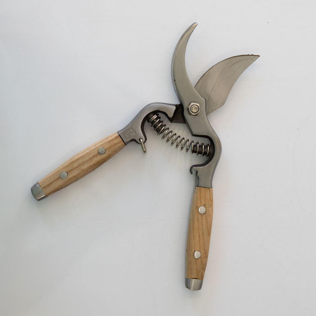 Ash handled pruning clippers with drop forged stainless blades.