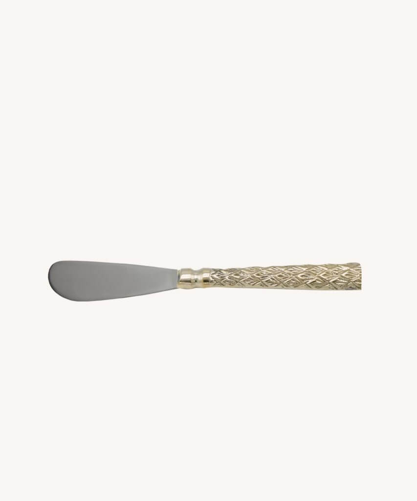 Spreader with intricate brass handle and stainless steel knife.