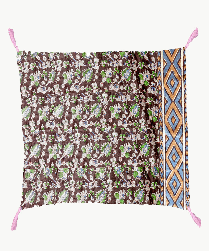 One side of reversible pillow is floral print with one geometric edge.