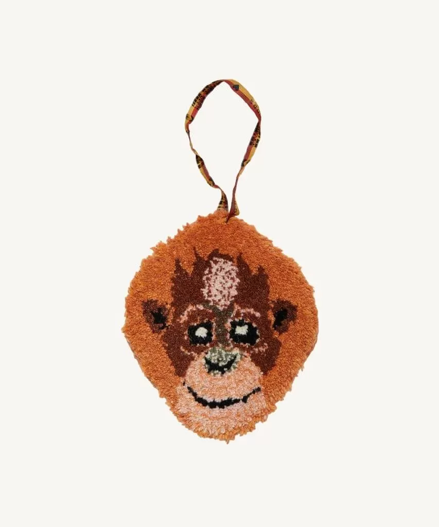 A hand tufted orangutan head that can be used as a gift hanger or on a wall to add whimsy!